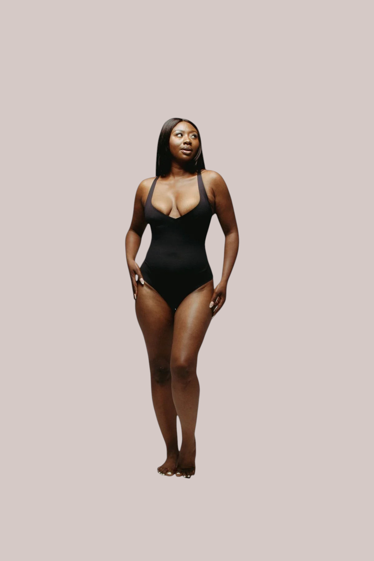 Model wearing an Inshapewear™ black seamless sculpting bodysuit with a deep V-neckline and adjustable straps.