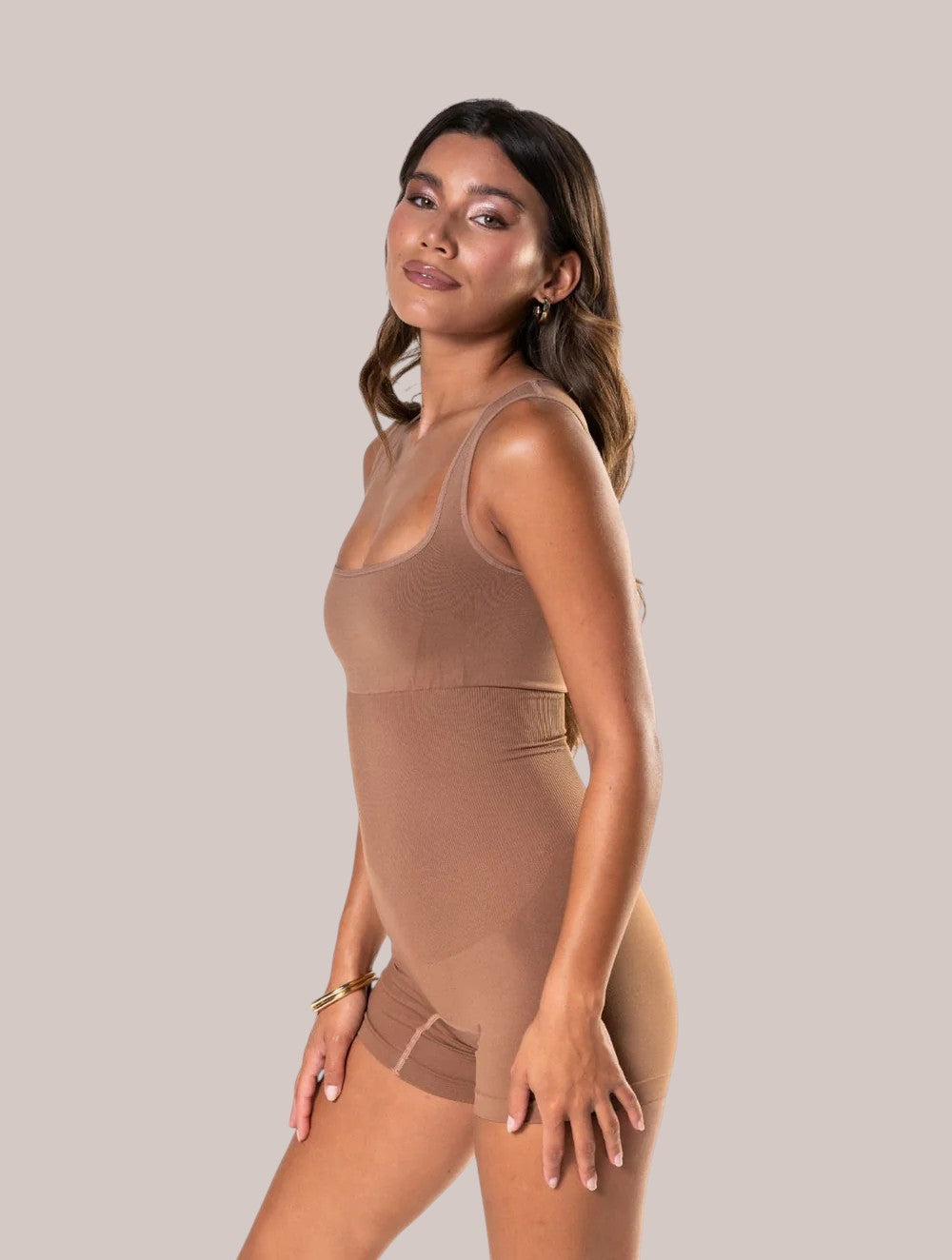 Model wearing a beige Inshapewear™ square neck shaping bodysuit with a seamless, breathable, and sculpting design.