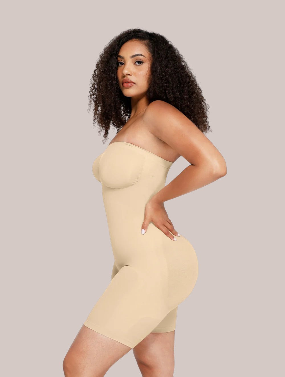 Model wearing Inshapewear™ beige strapless shaping bodysuit that smooths the waist and hips for a seamless silhouette.