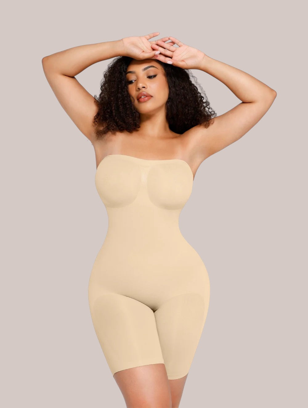 Model wearing Inshapewear™ beige strapless shaping bodysuit for a smooth silhouette and tummy control