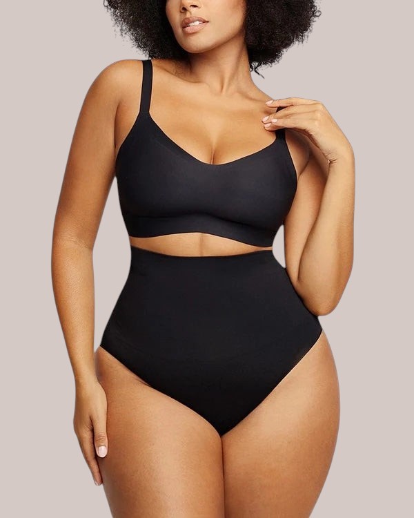 Model wearing Inshapewear™ black high-waisted shaping briefs and matching bralette against a neutral background.