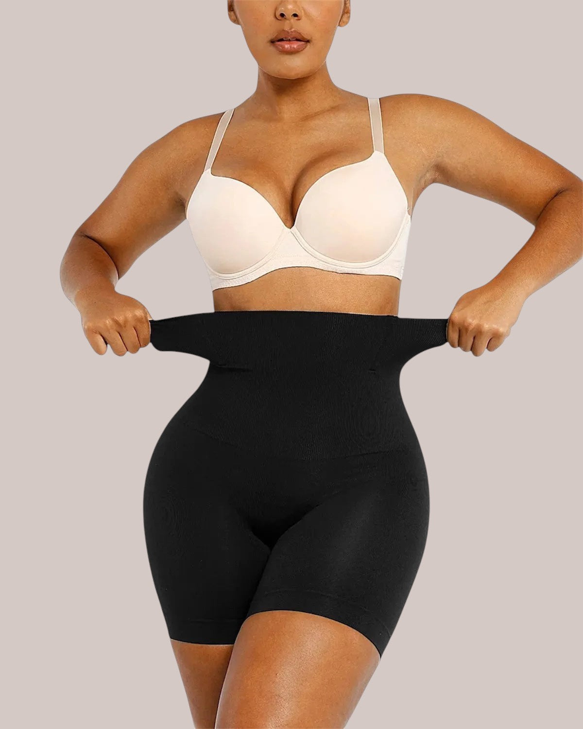 Model wearing black Inshapewear™ high-waisted shaping shorts for tummy control and a smooth silhouette