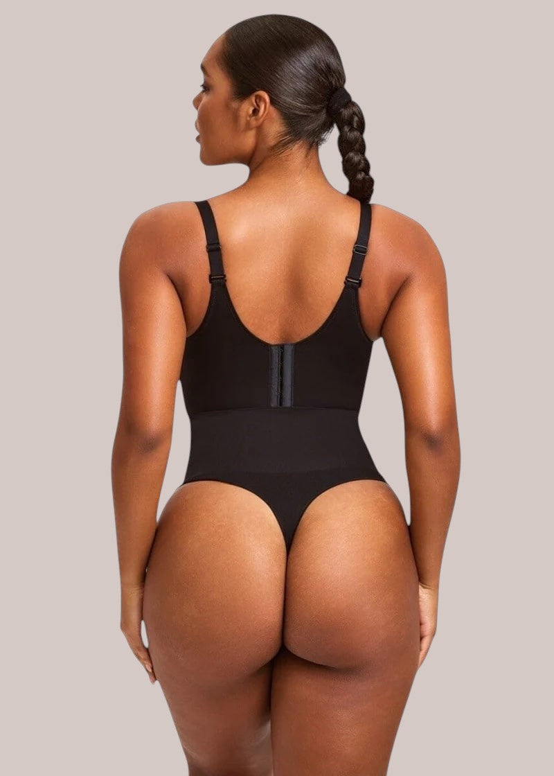 Back view of a model wearing an Inshapewear™ black high-waisted thong shapewear bodysuit with adjustable straps.