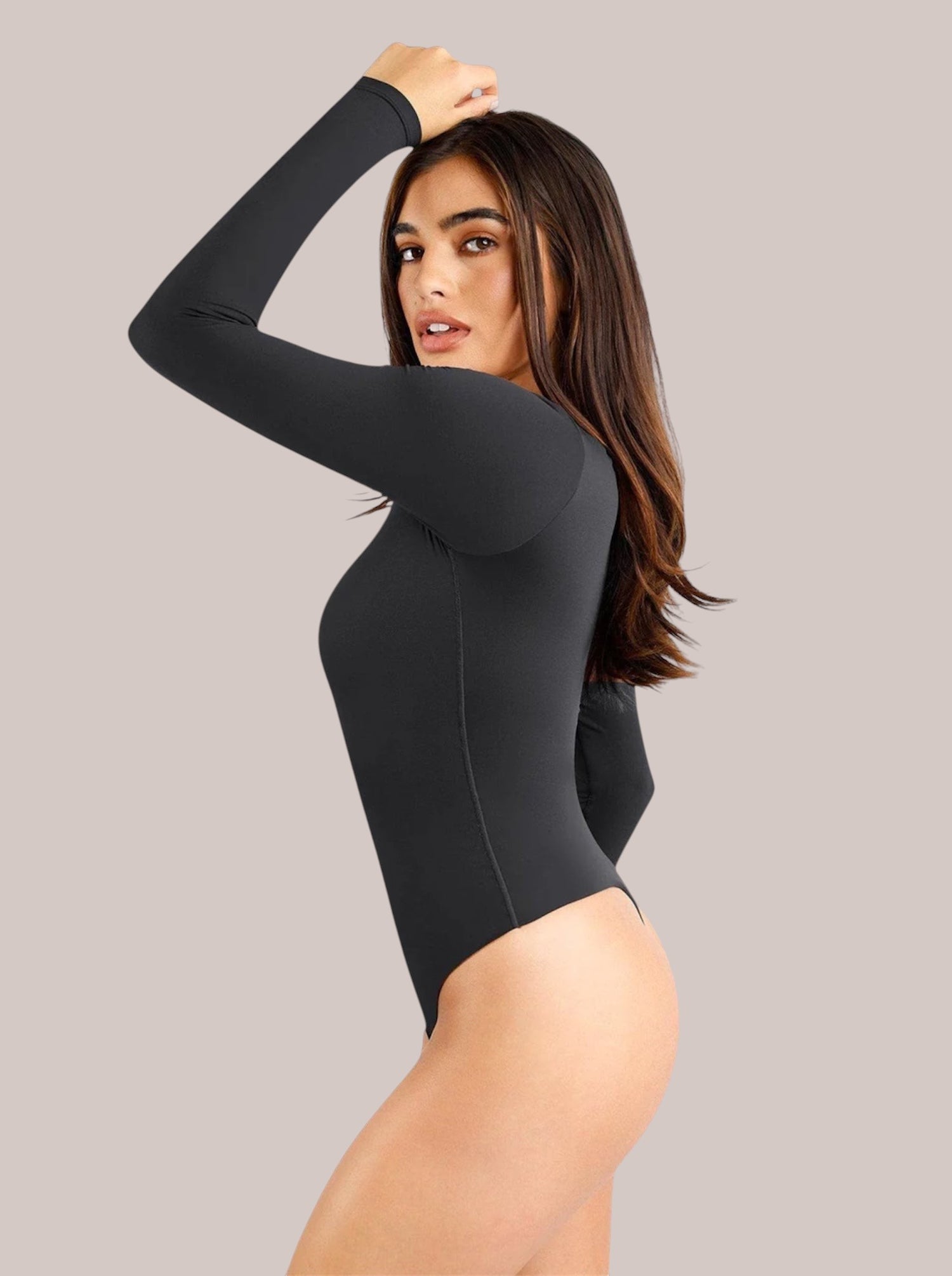 Model wearing a black Inshapewear™ long-sleeve shaping bodysuit with a square neckline and second-skin fit.