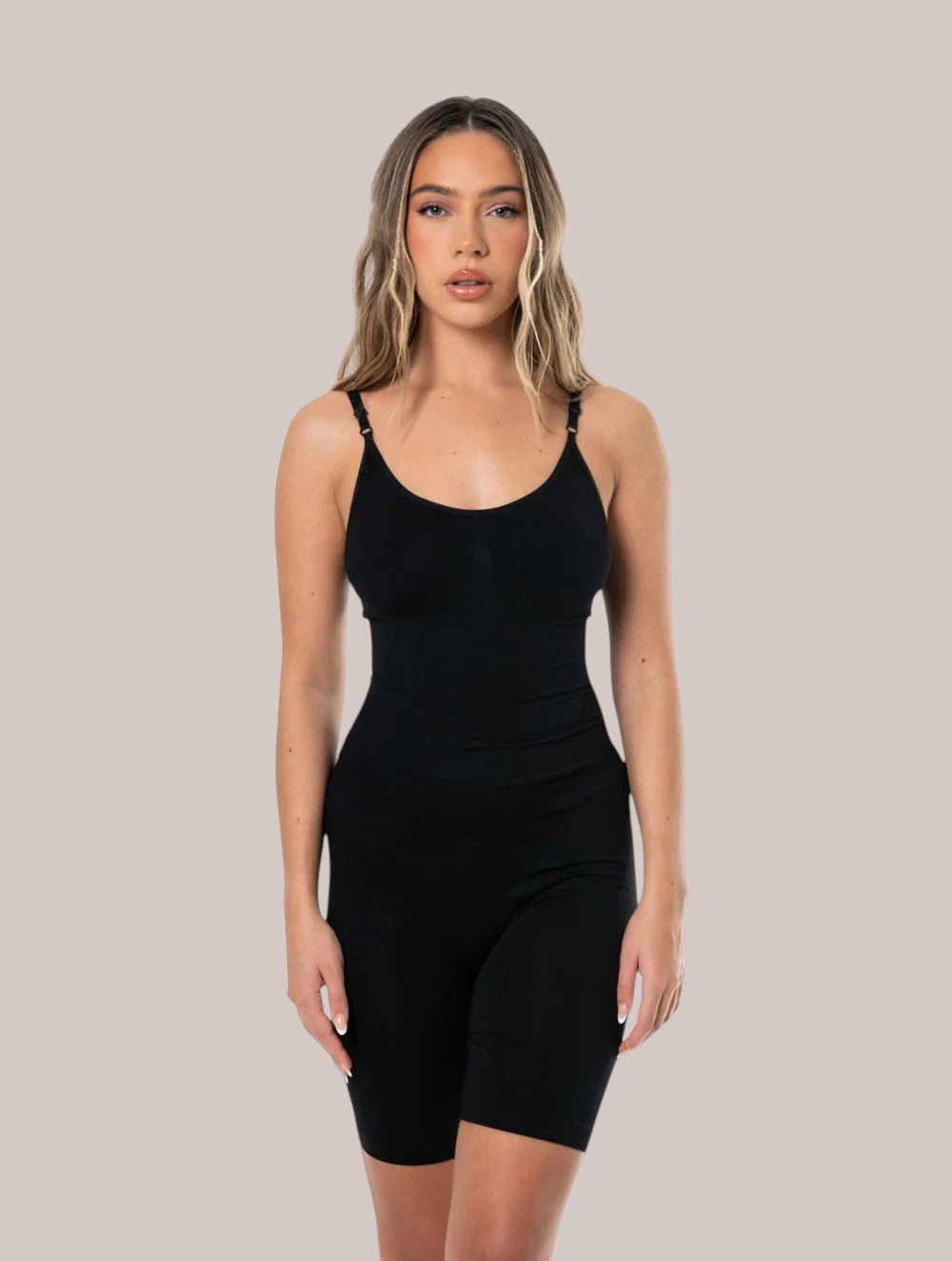 Model wearing Inshapewear™ black seamless shaping bodysuit with adjustable straps for a smooth silhouette