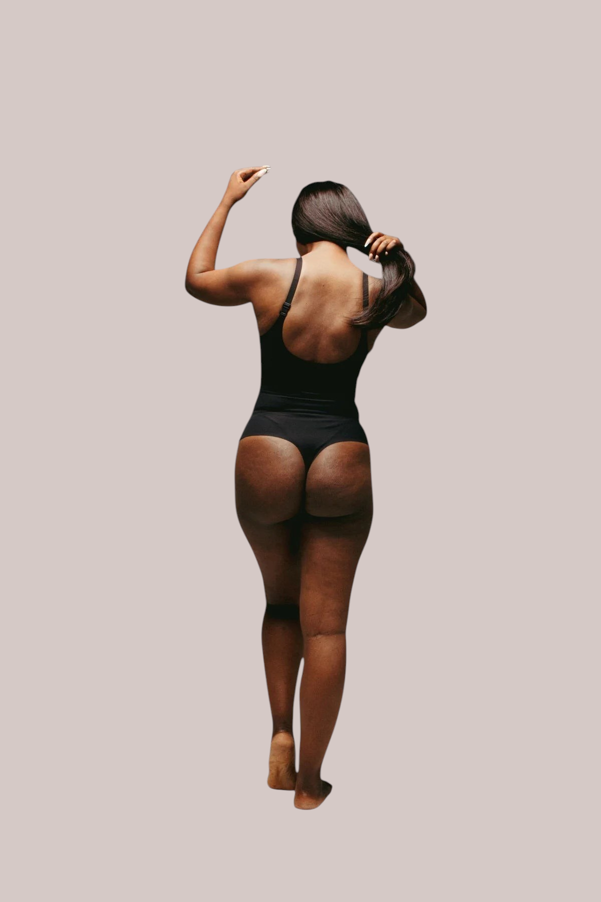 Inshapewear™ black seamless thong bodysuit on a model showing a smooth sculpted silhouette from the back