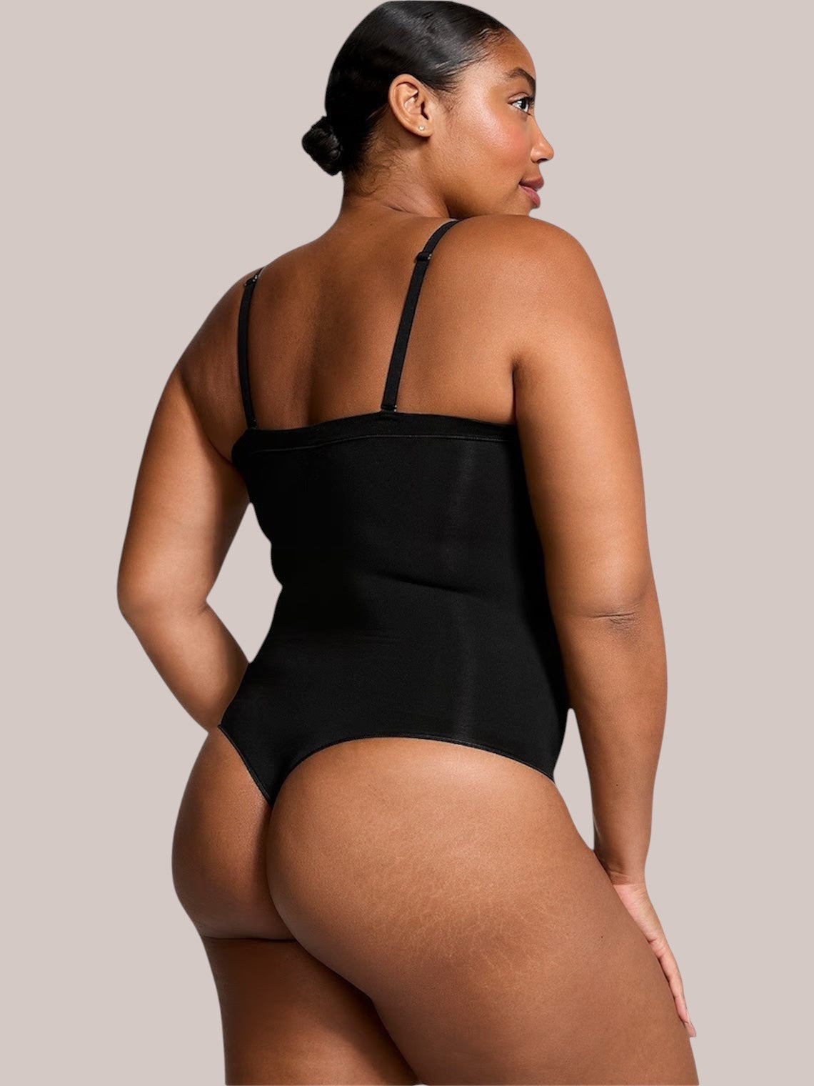 Model wearing a black Inshapewear™ shaping bodysuit with detachable straps, showing a smooth back view.