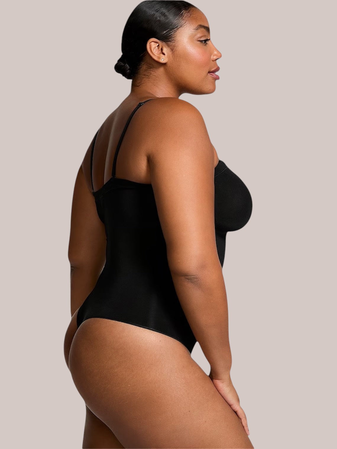 Inshapewear™ black shaping bodysuit with detachable straps worn by a model, featuring a smooth, sculpting fit.