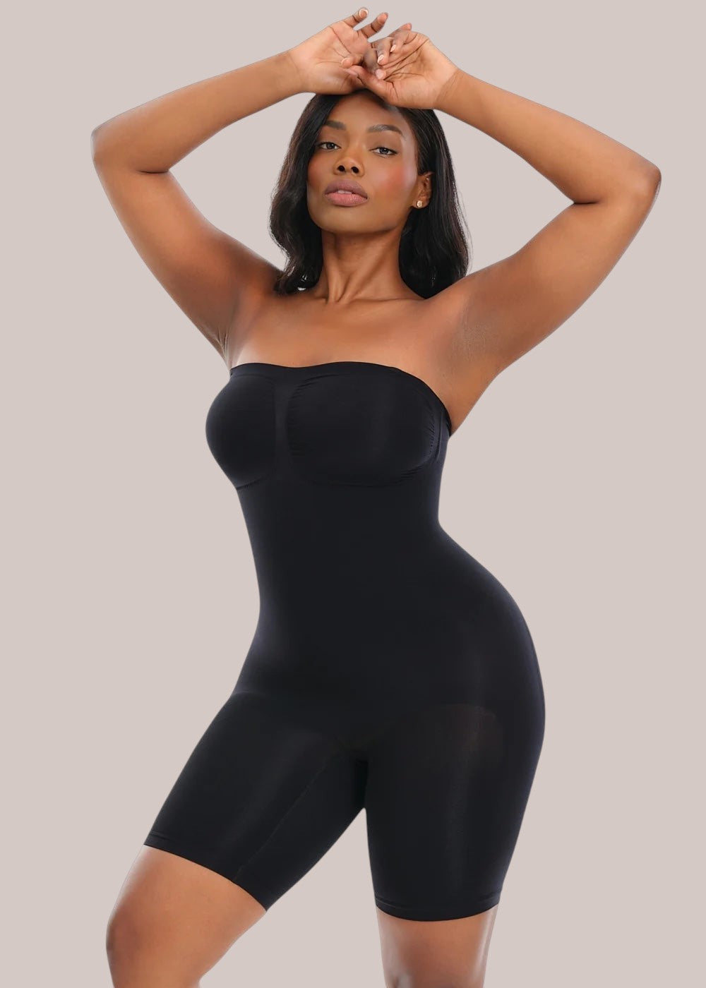 Model wearing a black Inshapewear™ strapless shaping bodysuit that smooths the waist, hips, and stomach.