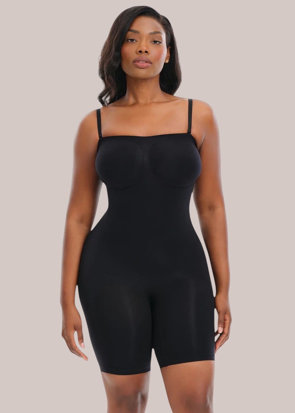 Model wearing a black Inshapewear™ strapless shaping bodysuit that smooths the waist, hips, and stomach.