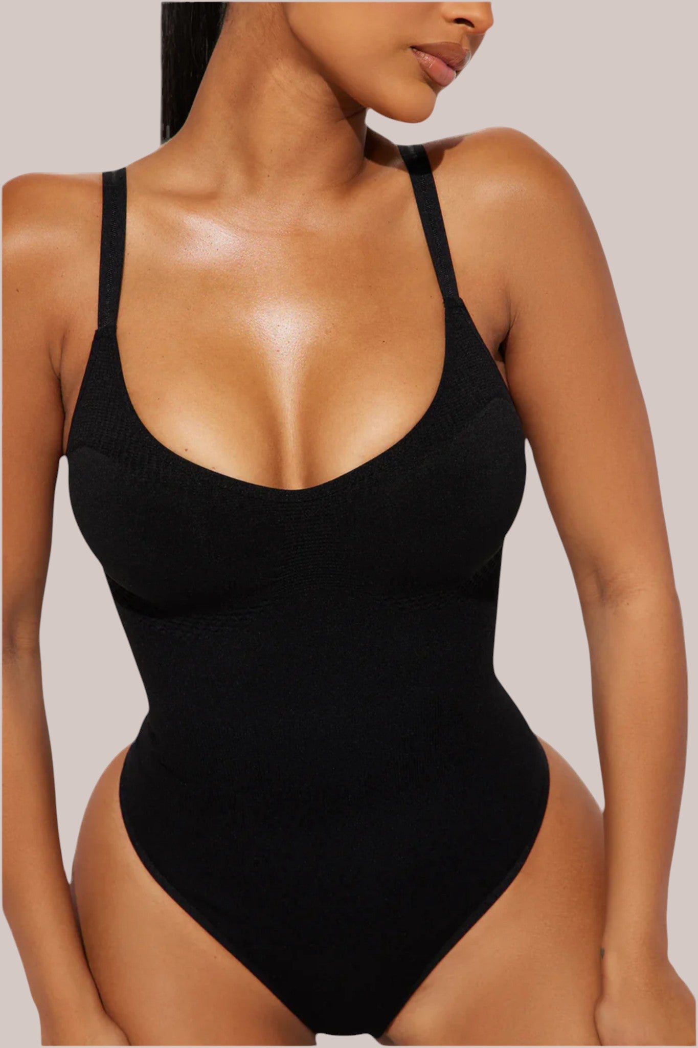 Inshapewear™ black thong bodysuit with targeted compression for a smooth, sculpted silhouette and second-skin fit.