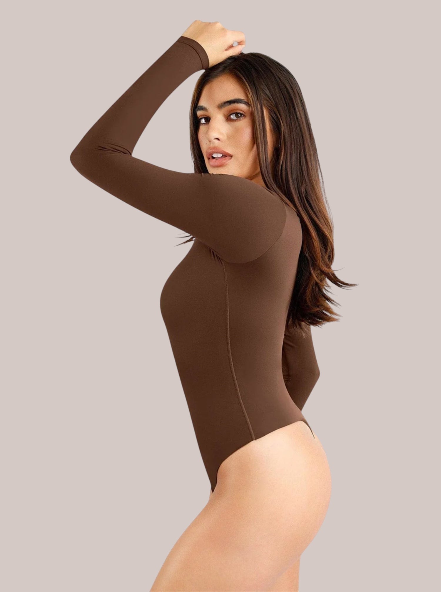 Model wearing a brown Inshapewear™ long-sleeve shaping bodysuit with a square neckline and smooth, breathable fabric.