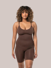 Model wearing a brown Inshapewear™ seamless shaping bodysuit with adjustable straps for a smooth silhouette.