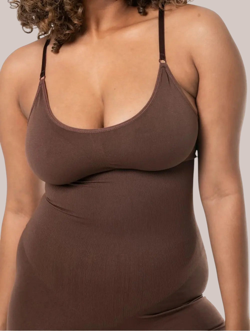 Inshapewear™ brown seamless shaping bodysuit with adjustable straps providing targeted compression and a smooth fit.