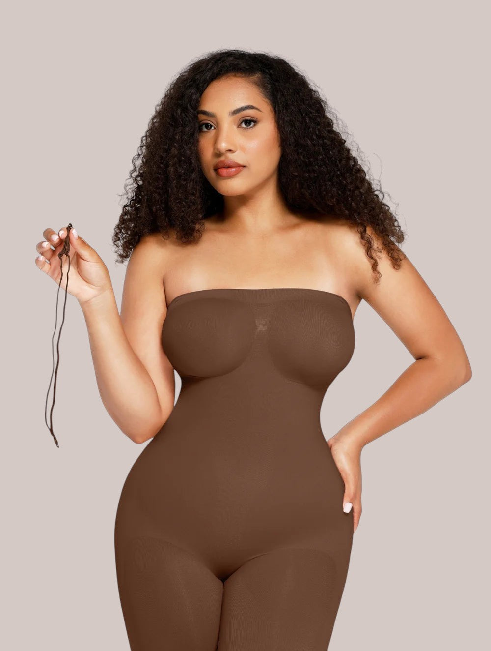 Model wearing a brown Inshapewear™ strapless shaping bodysuit that smooths the waist and hips for a sleek silhouette.