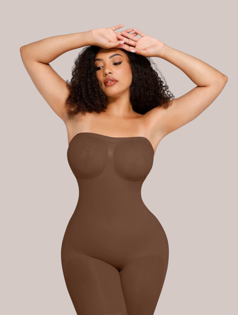 Model wearing a brown Inshapewear™ strapless shaping bodysuit for a smooth silhouette and waist slimming effect.