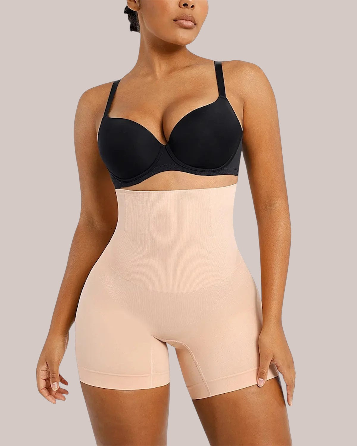Model wearing Inshapewear™ high-waisted beige shaping shorts for a smooth silhouette under clothing