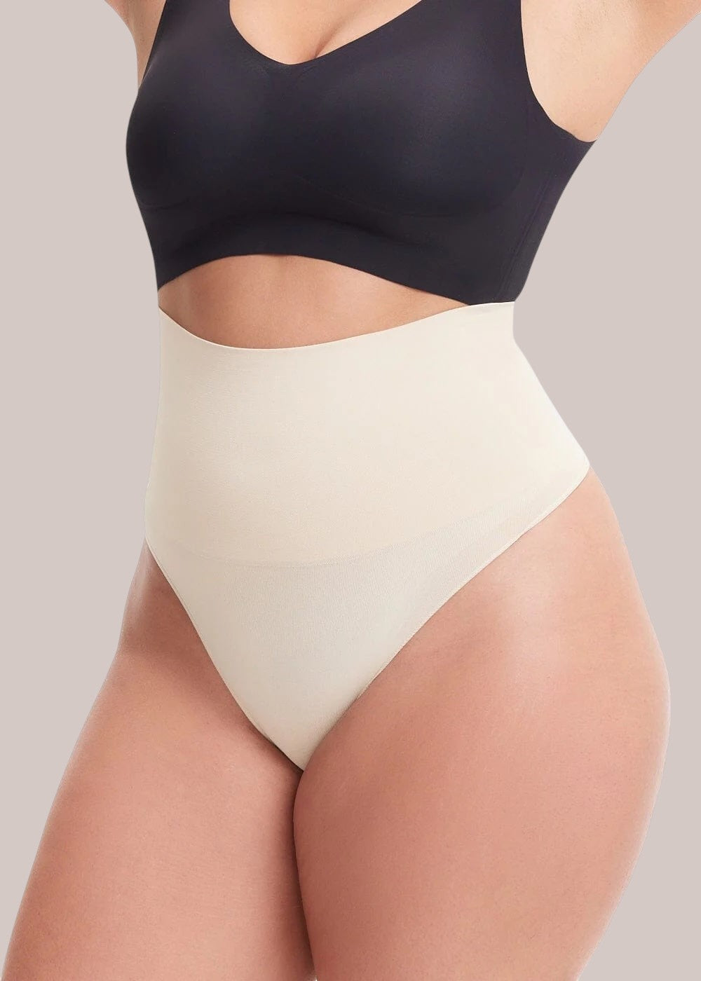 Inshapewear™ high-waisted beige shaping thong providing tummy control and a seamless fit on a model