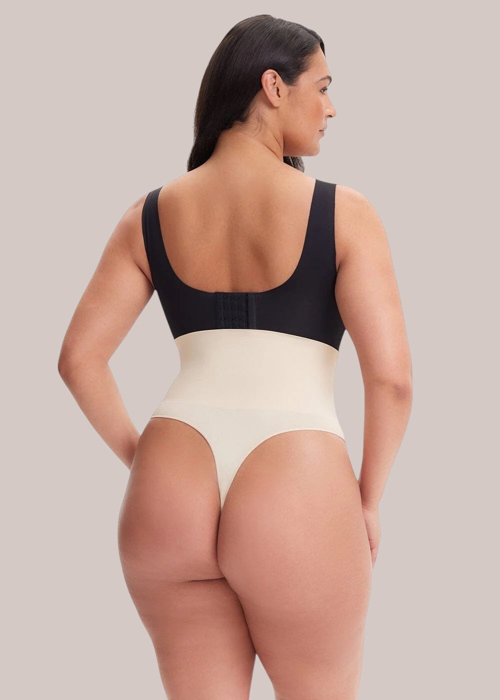 Inshapewear™ high-waisted beige and black thong shapewear bodysuit viewed from the back on a model