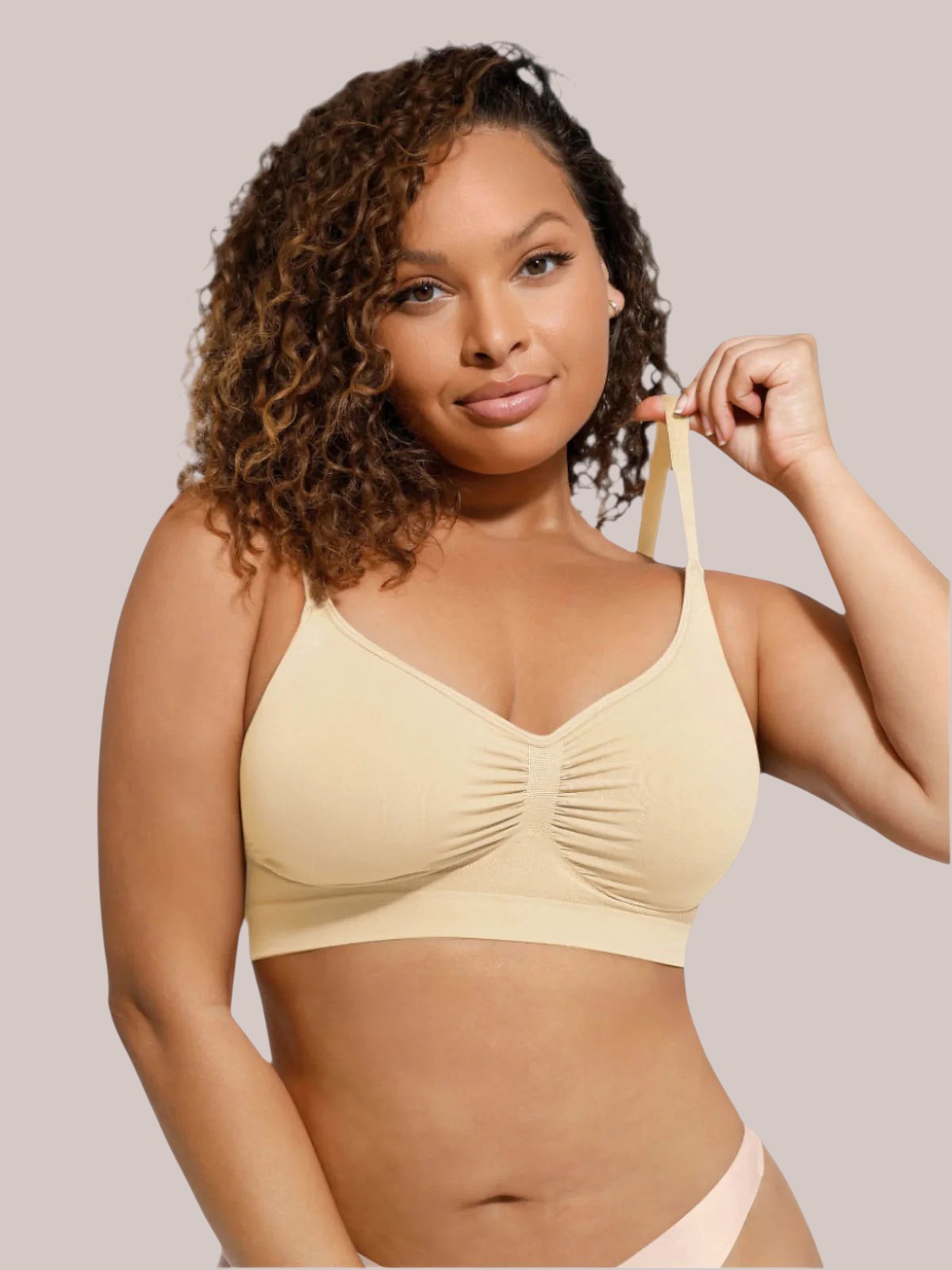 Model wearing a beige Inshapewear™ seamless bra with a ruched center detail, offering a smooth and supportive fit.