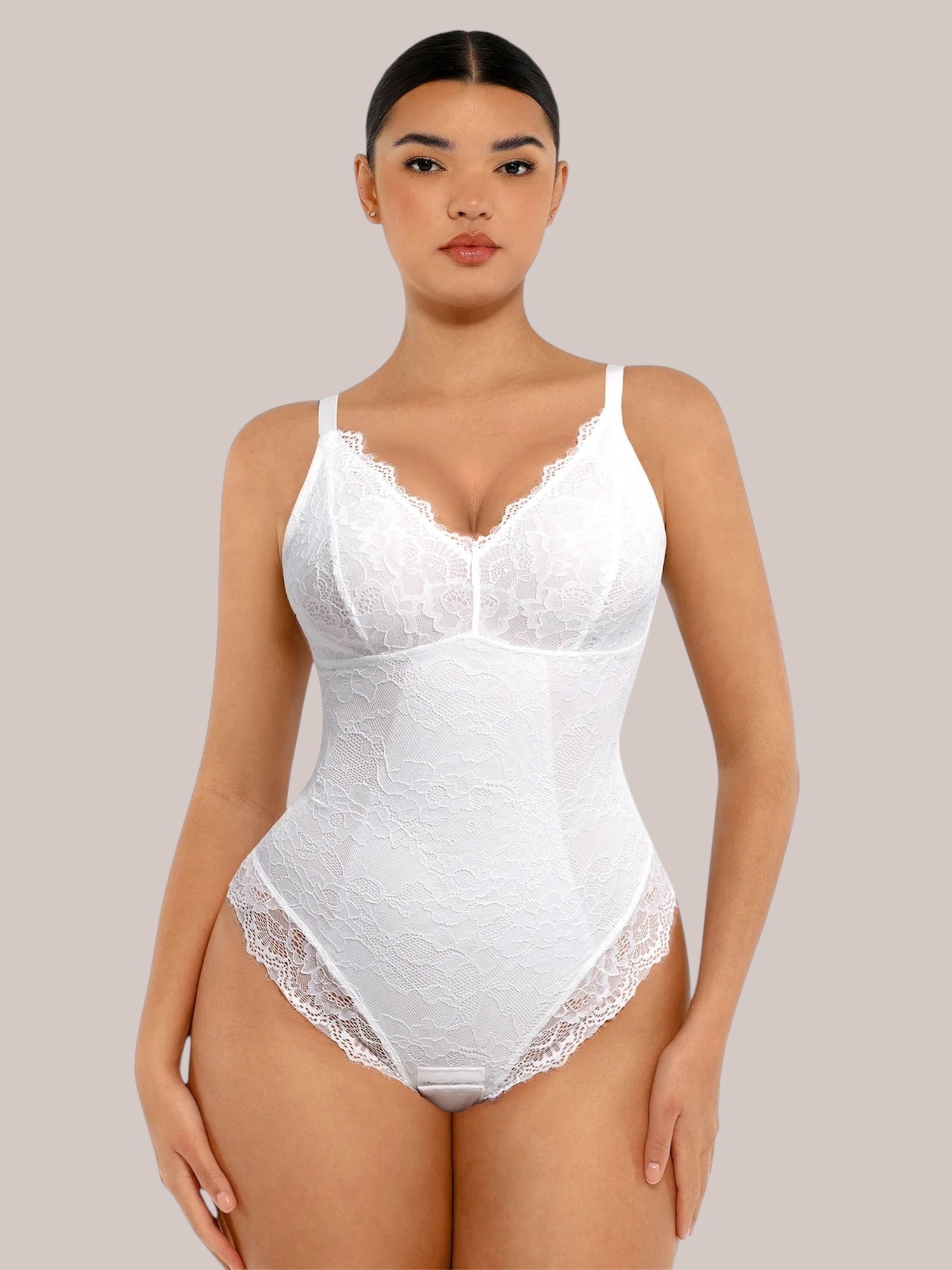 Inshapewear™ white lace bodysuit with a V-neckline and delicate floral pattern on a model against a white background.