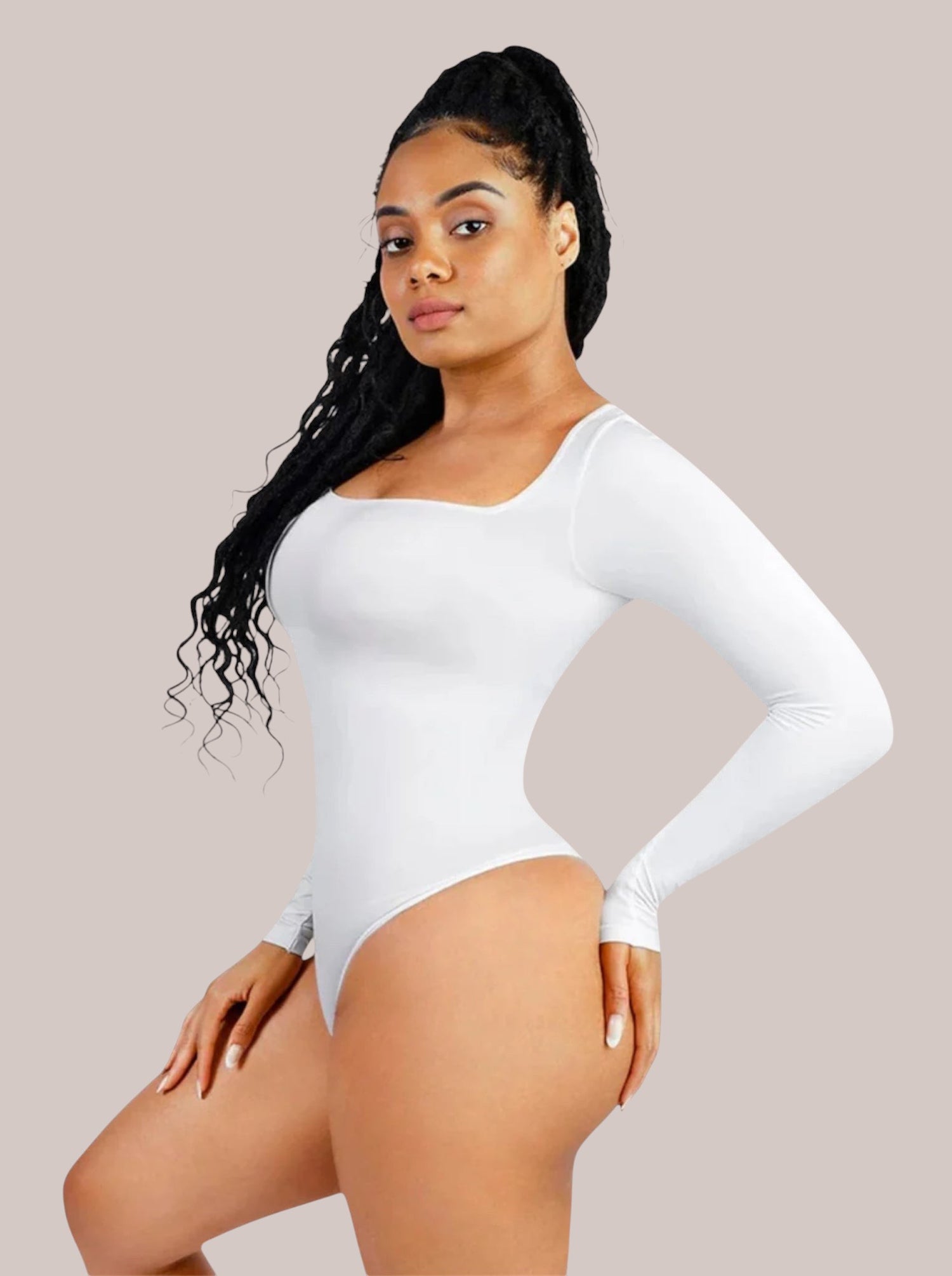 Model wearing a white Inshapewear™ long-sleeve shaping bodysuit with a square neckline and breathable fabric.